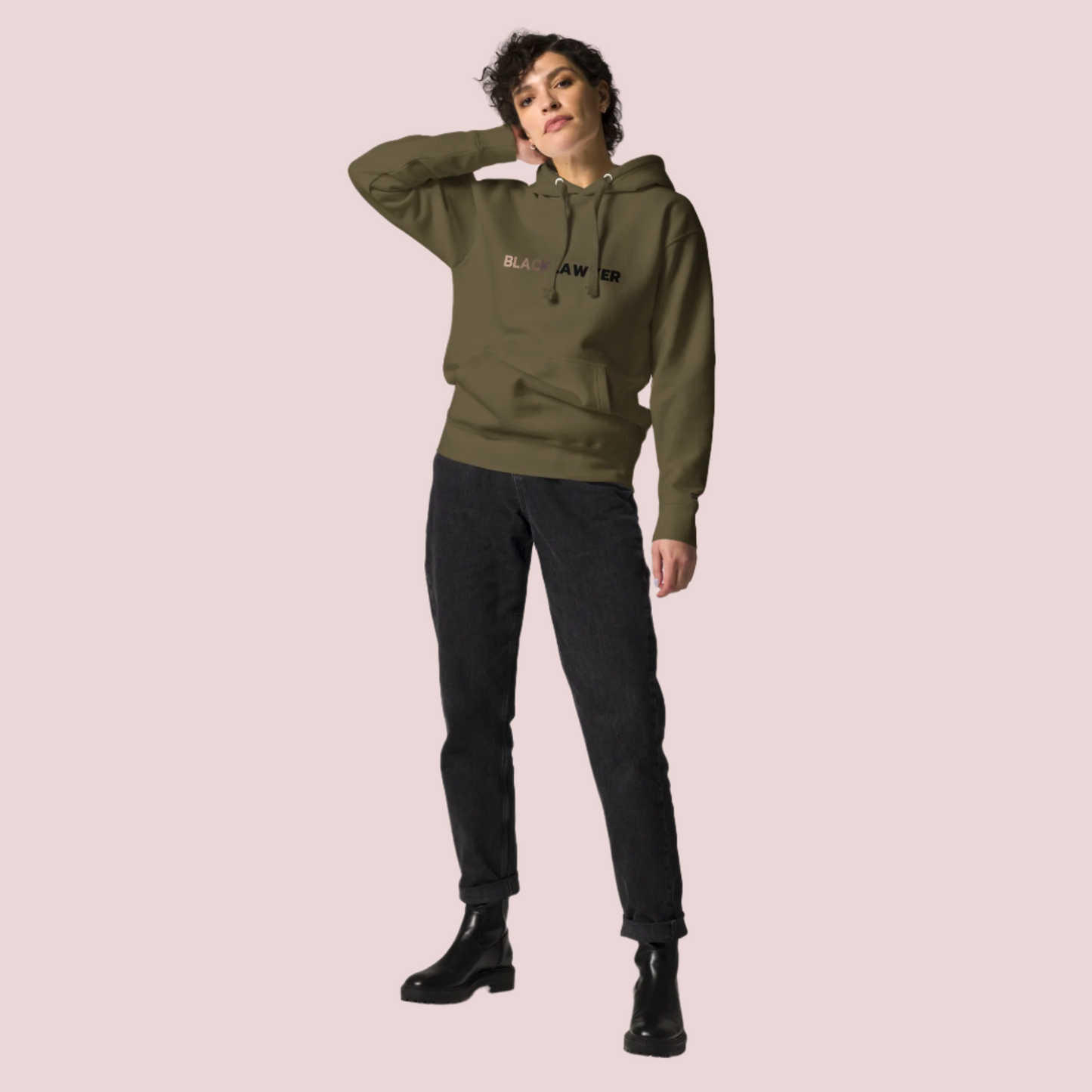 A model wearing black pants and an army green hoodie with the words "Black Lawyer" on it.