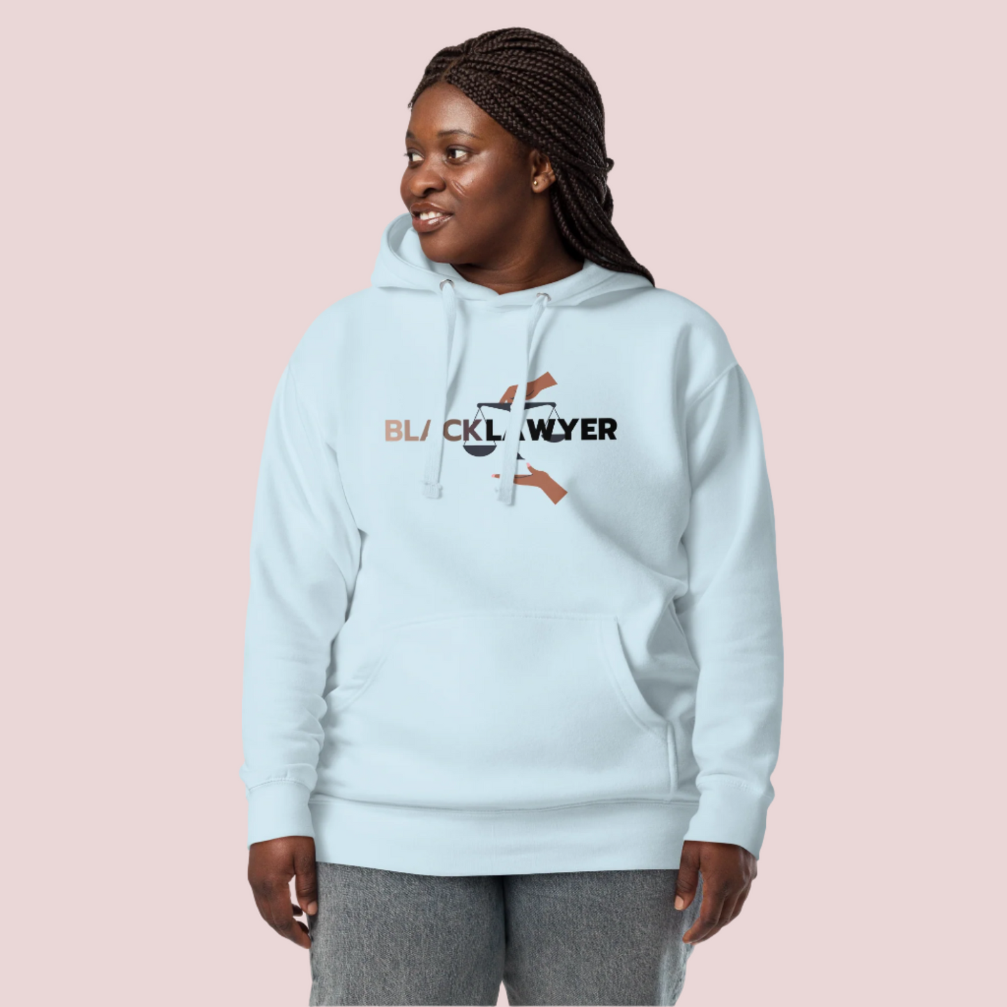 A model wearing jeans and an icy blue hoodie with the words "Black Lawyer" on it and a woman's hand holding an imbalanced justice scale.