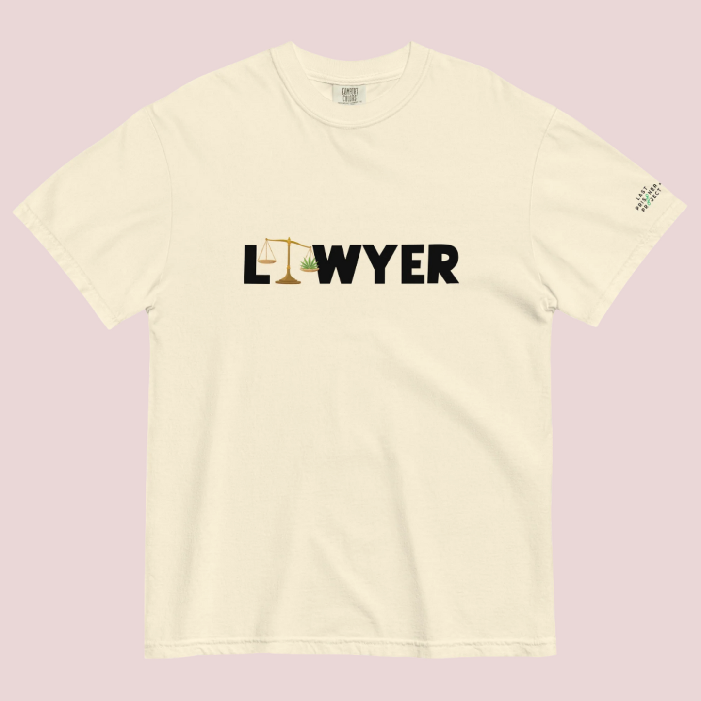 A cream crewneck tee showing the text "LAWYER", with the letter "A" stylized as a set of tilted justice scales, with one scale pan containing cannabis leaves while the other pan remains empty, with The last Prisoner Project x The Counselle Collection logo on the left sleeve.