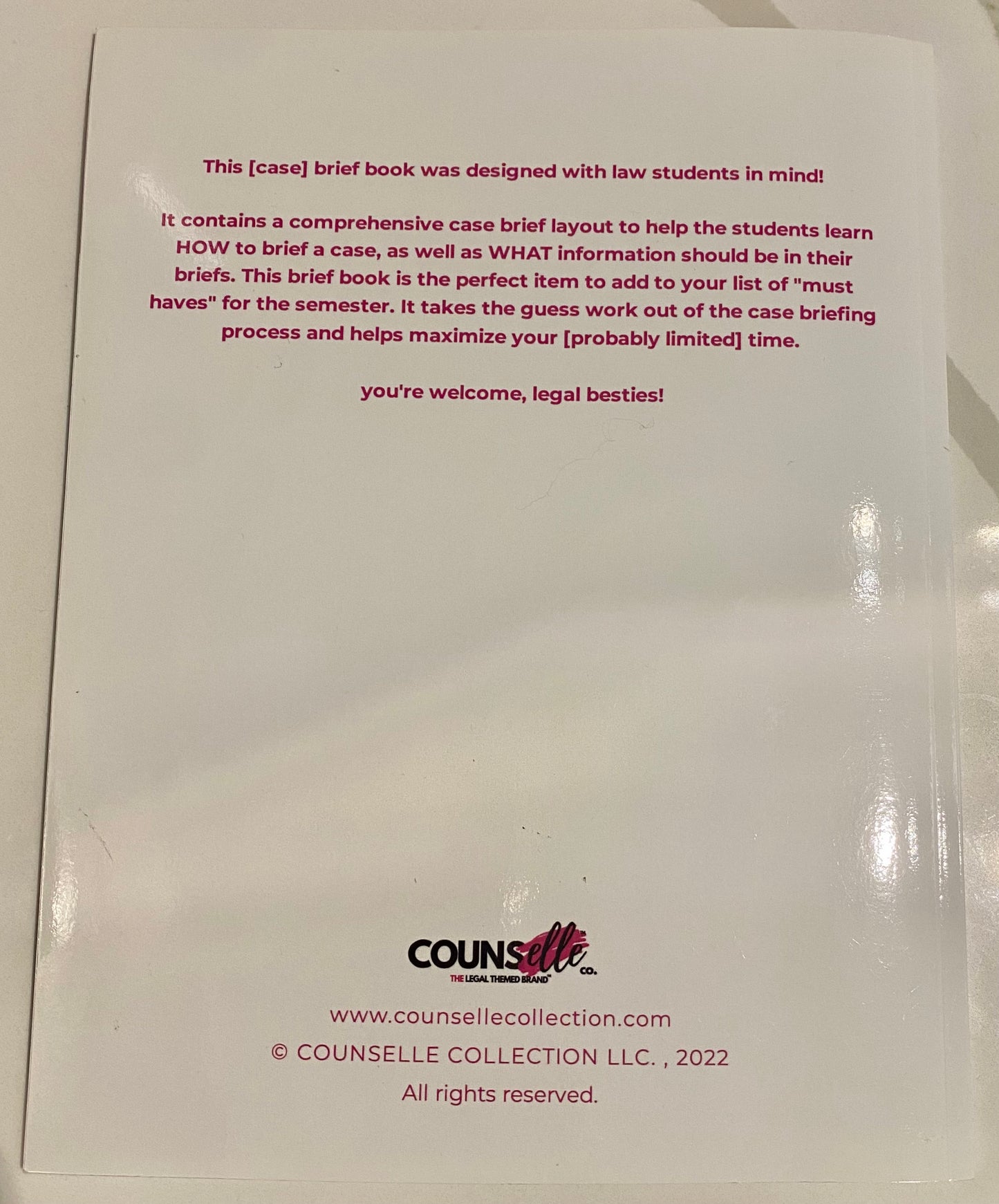 Back cover of a case brief book featuring a short message in small pink sans serif font, with the counsellecollection logo at the bottom