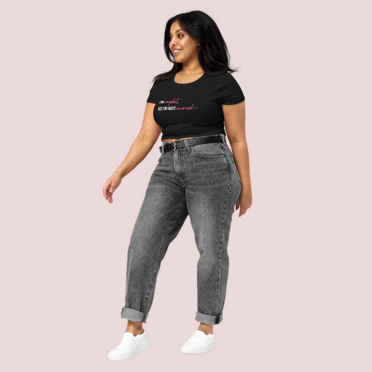 A model wearing white sneakers, jeans, and a black roundneck cropped tee with the slogan "I'm competent, so I'm not concerned".