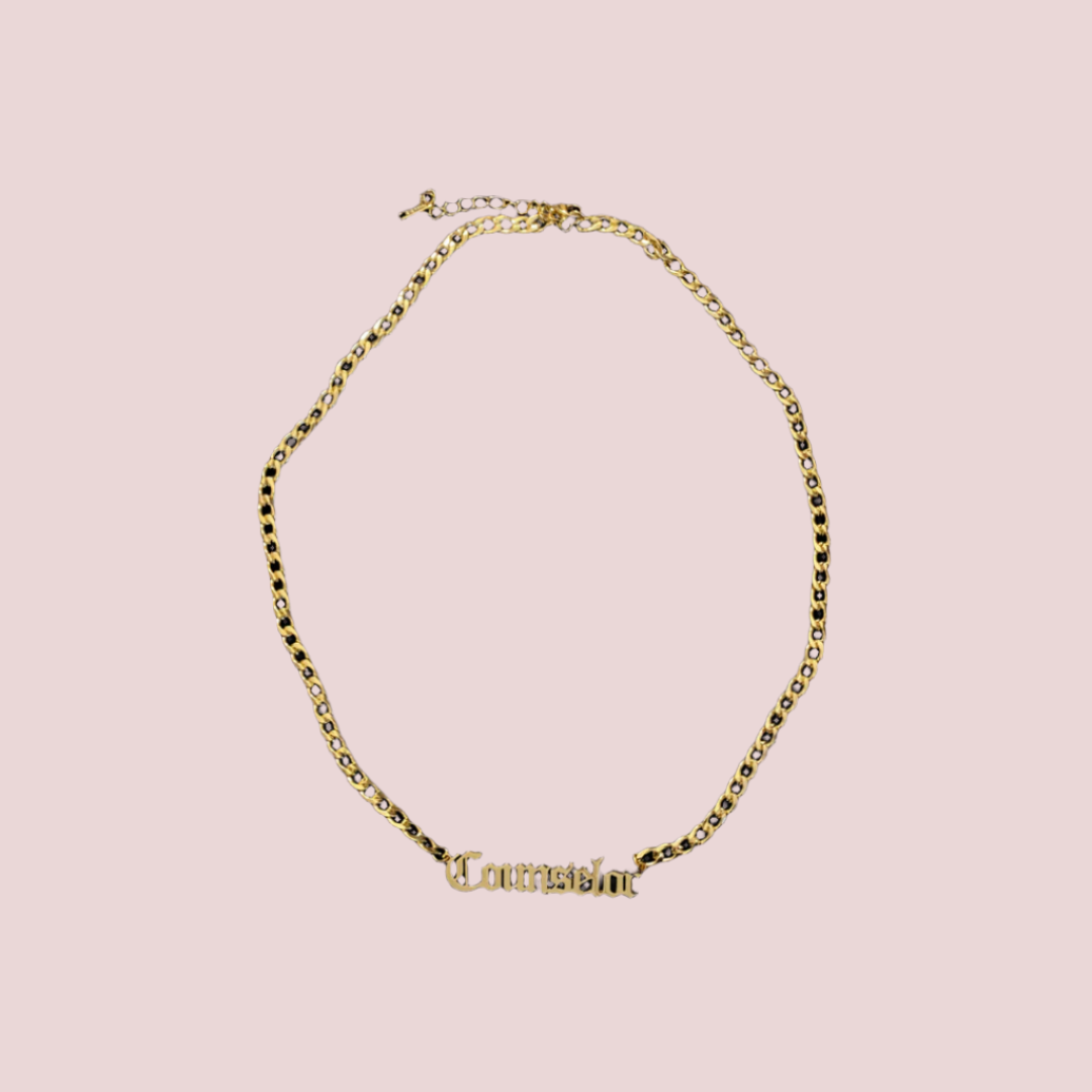 A gold chain necklace featuring the word "counselor" in old English text.