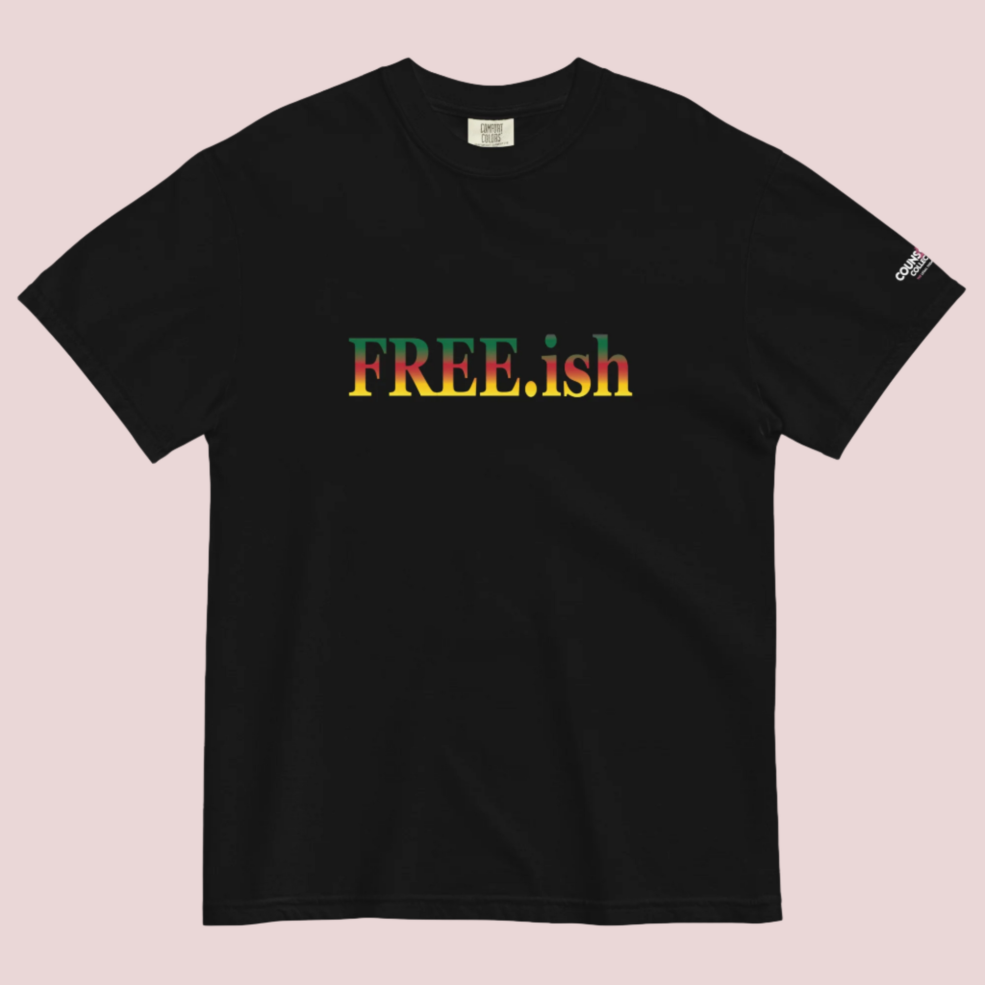 A black roundneck tee featuring the text "FREE.ish" in green, red, and yellow striped font, with the counsellecollection logo on the left sleeve.