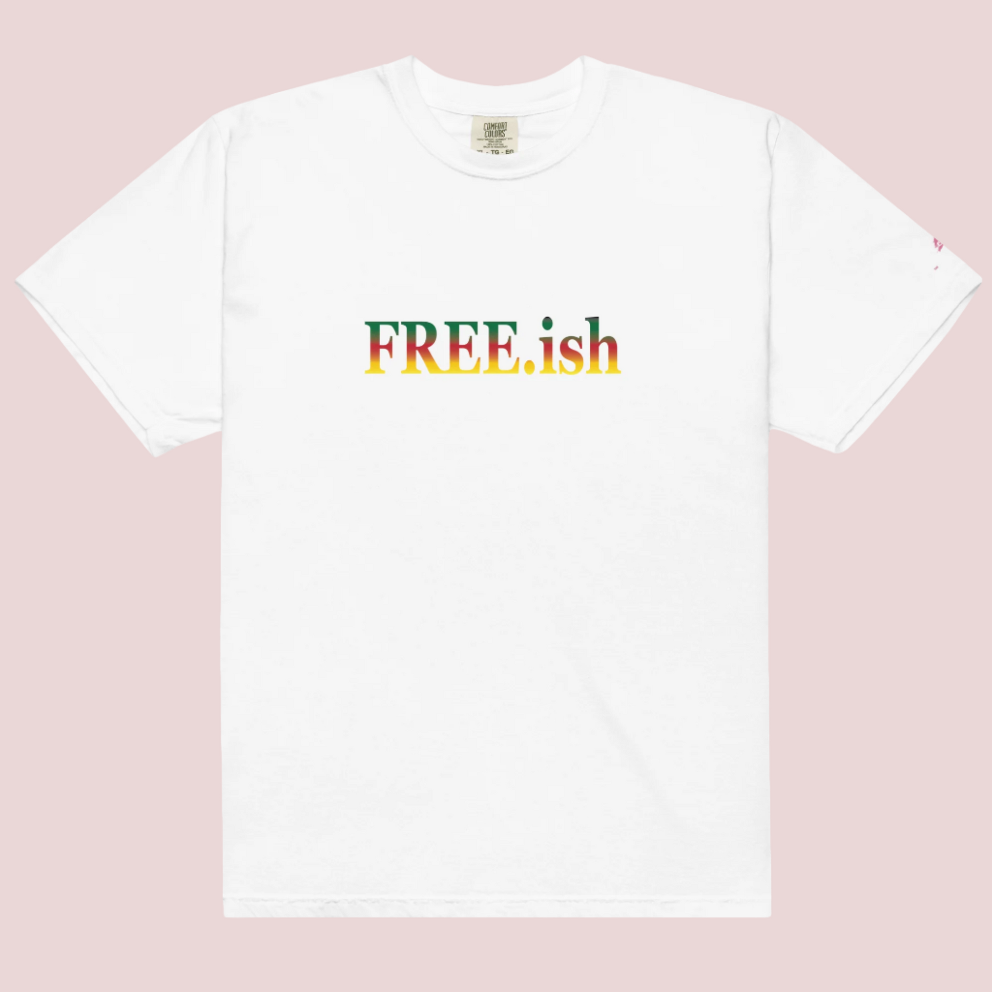 A white roundneck tee featuring the text "FREE.ish" in green, red, and yellow striped font, with the counsellecollection logo on the left sleeve.