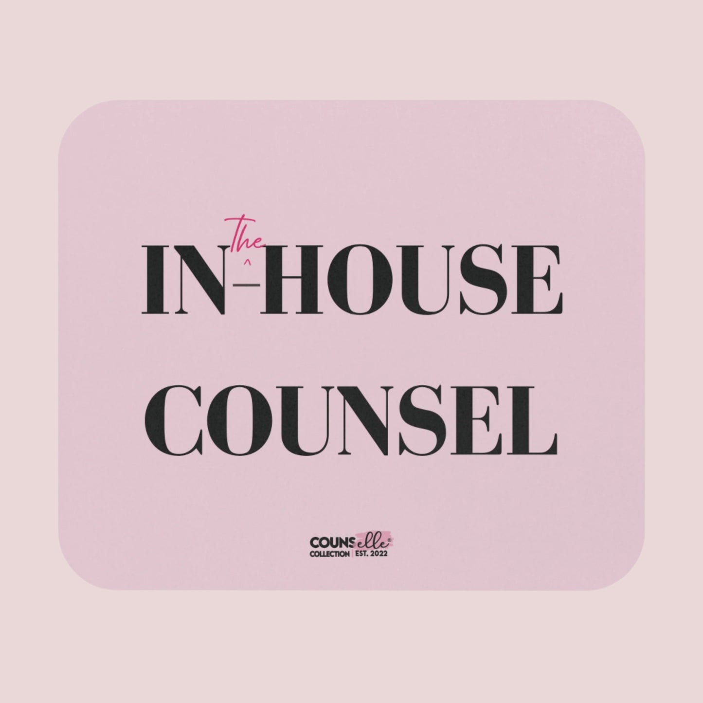 A rectangular, pink mousepad showing the text "IN", "^", "the", "-HOUSE", and COUNSEL", with the counsellecollection logo at the bottom of the design.