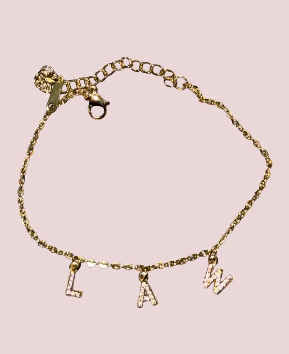 A bracelet with the word "LAW" in classic stones as charms.