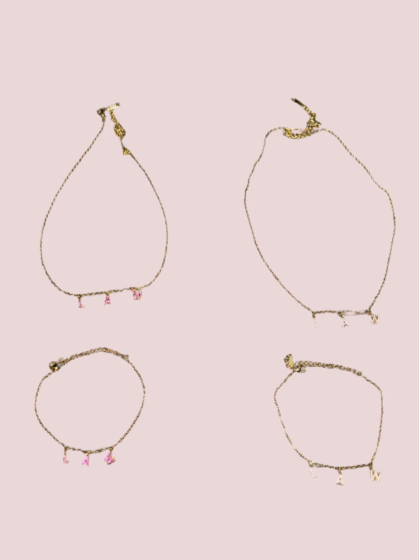 Two necklaces and two bracelets with the word "LAW" in hot pink and classic stones as charms.