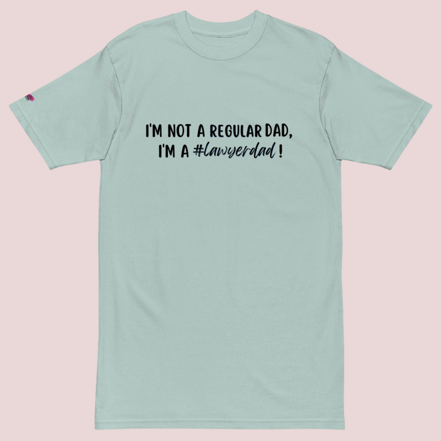 An aqua roundneck tee with the text "I'm not a regular dad, I'm a #lawyerdad!"  and the counsellecollection logo on the sleeve.