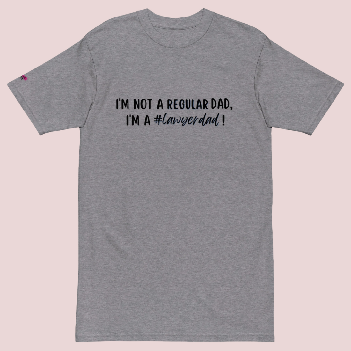 A grey roundneck tee with the text "I'm not a regular dad, I'm a #lawyerdad!"  and the counsellecollection logo on the sleeve.