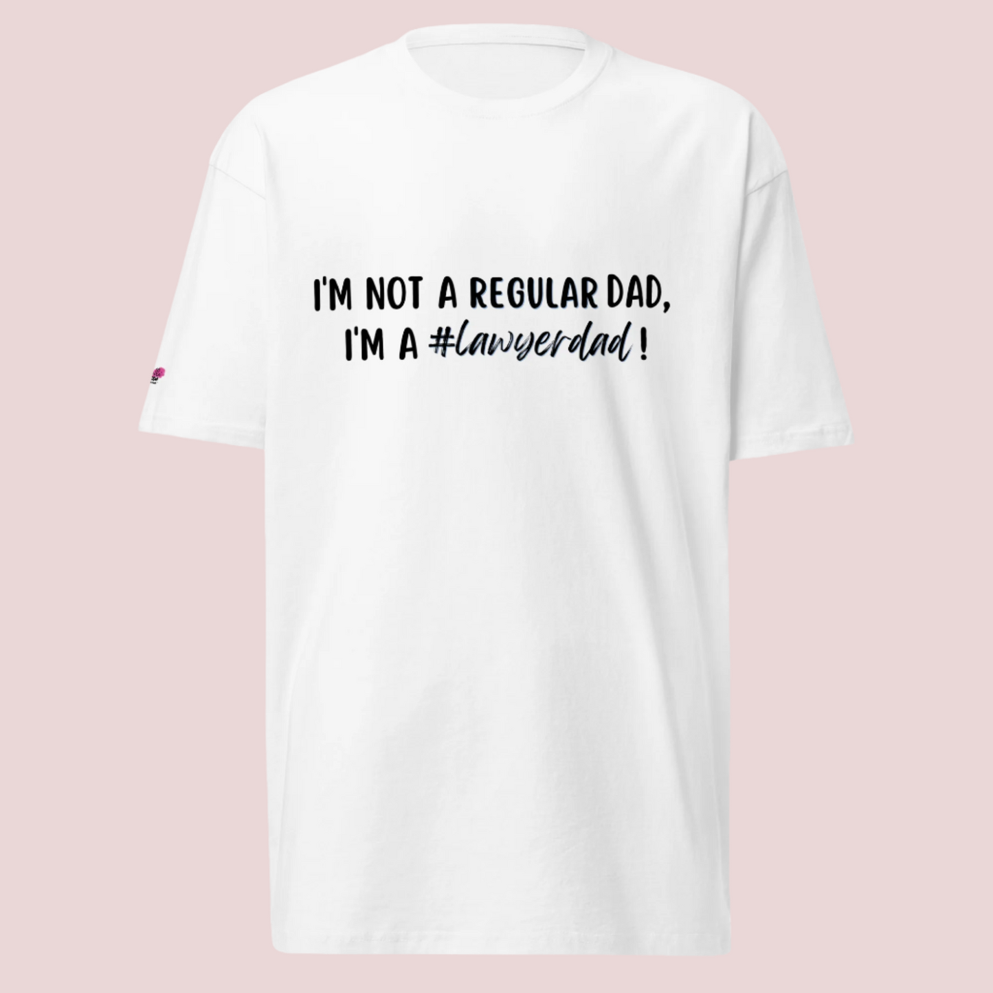 A white roundneck tee with the text "I'm not a regular dad, I'm a #lawyerdad!"  and the counsellecollection logo on the sleeve.