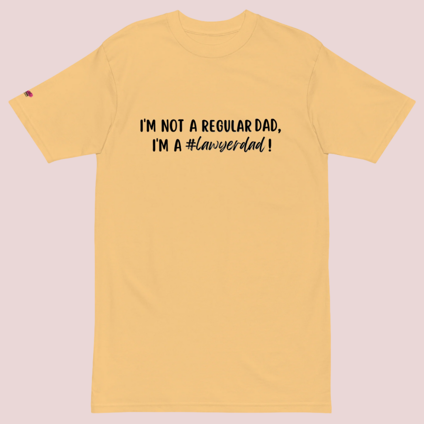 A yellow roundneck tee with the text "I'm not a regular dad, I'm a #lawyerdad!"  and the counsellecollection logo on the sleeve.