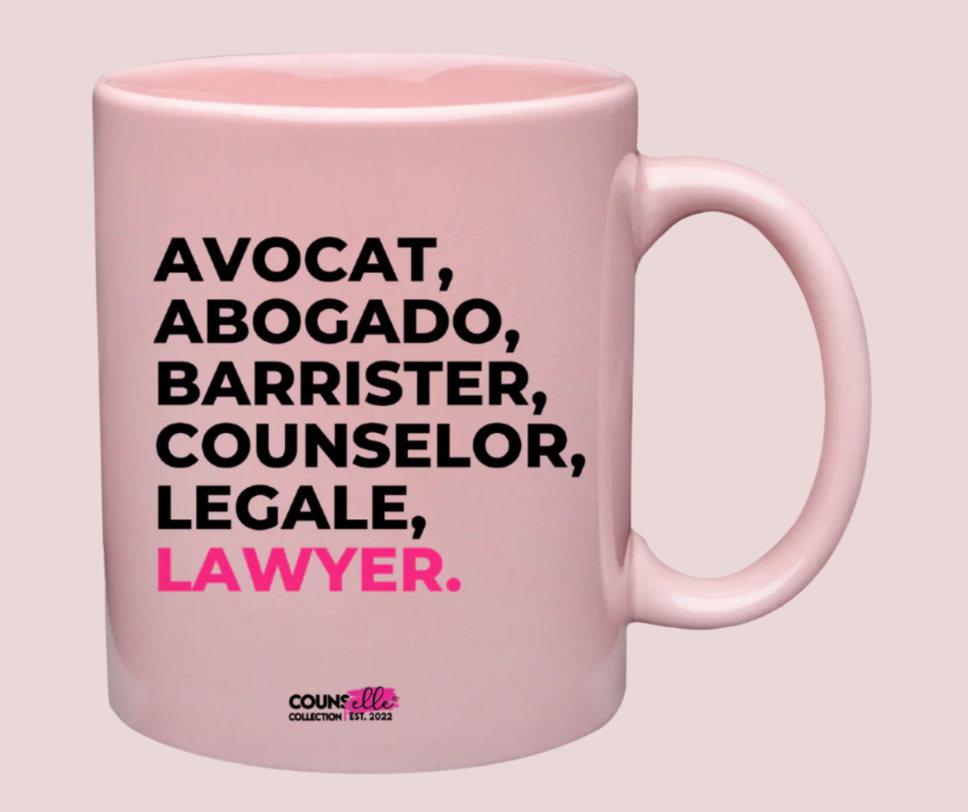 A blush pink mug, with the text "avocat", "abogado", "barrister", "counselor", "legale", and "lawyer" on the front. Counselle Collection® logo under text.