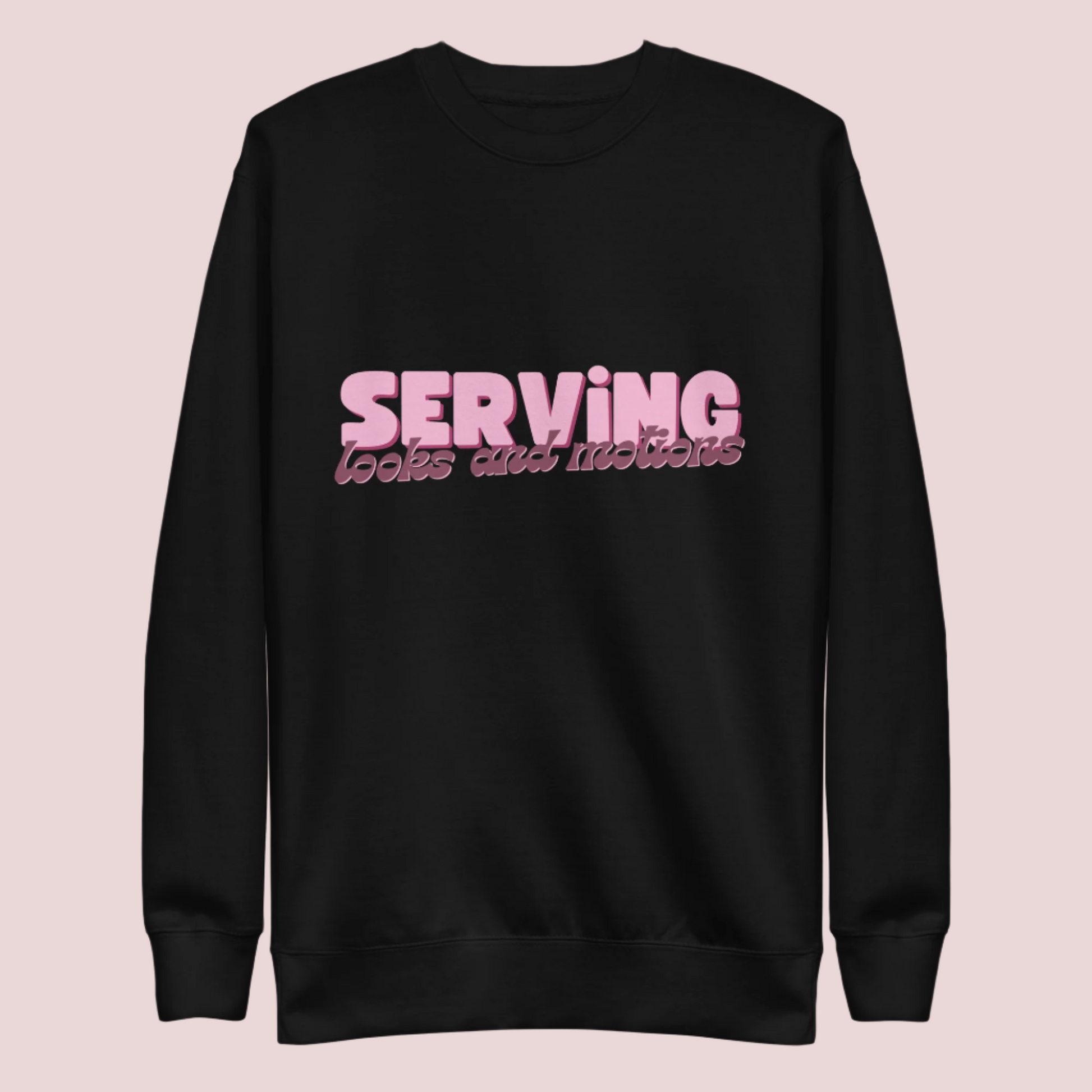 A black sweatshirt showing the text "SERVING looks and motions" in pink font.