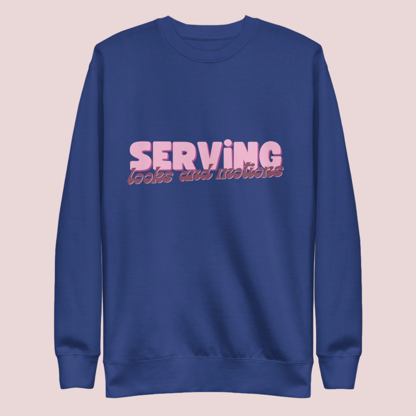 A royal blue sweatshirt showing the text "SERVING looks and motions" in pink font.