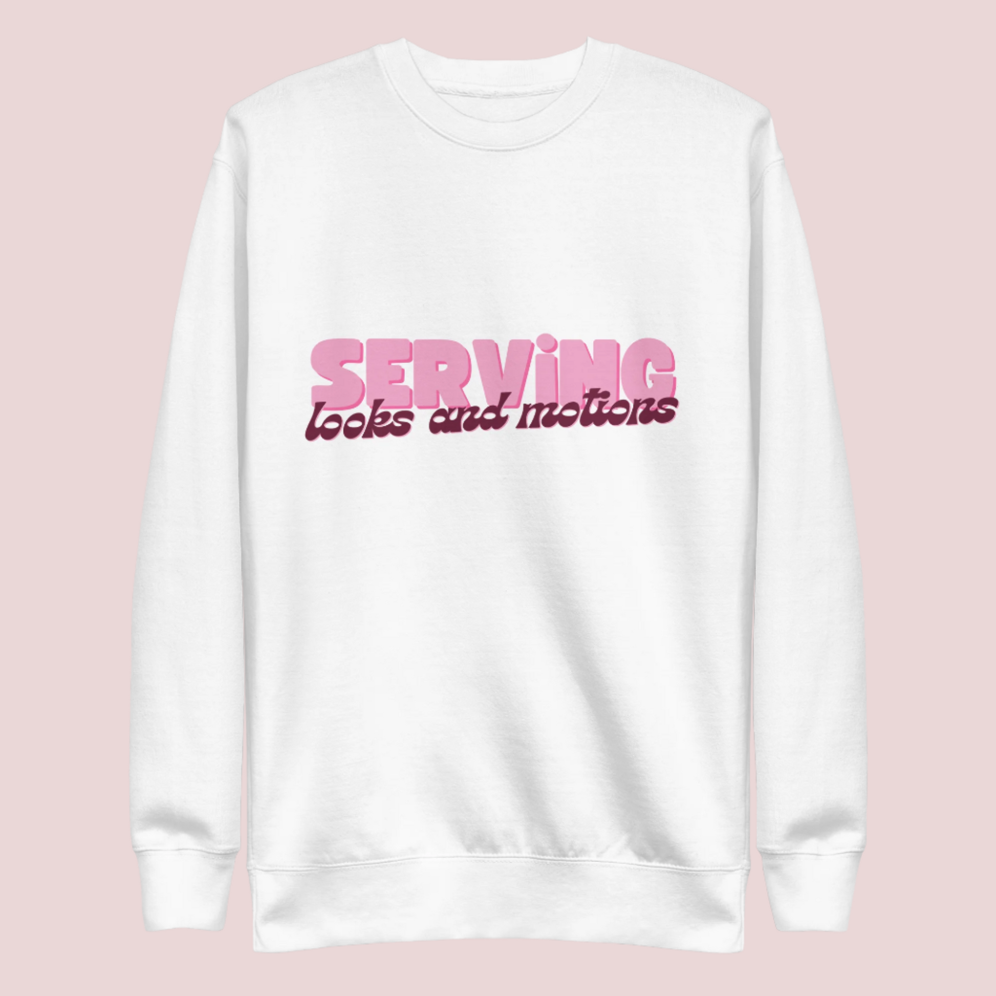 A white sweatshirt showing the text "SERVING looks and motions" in pink font.