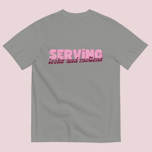 A grey roundneck tee showing the text "SERVING looks and motions" in pink font.