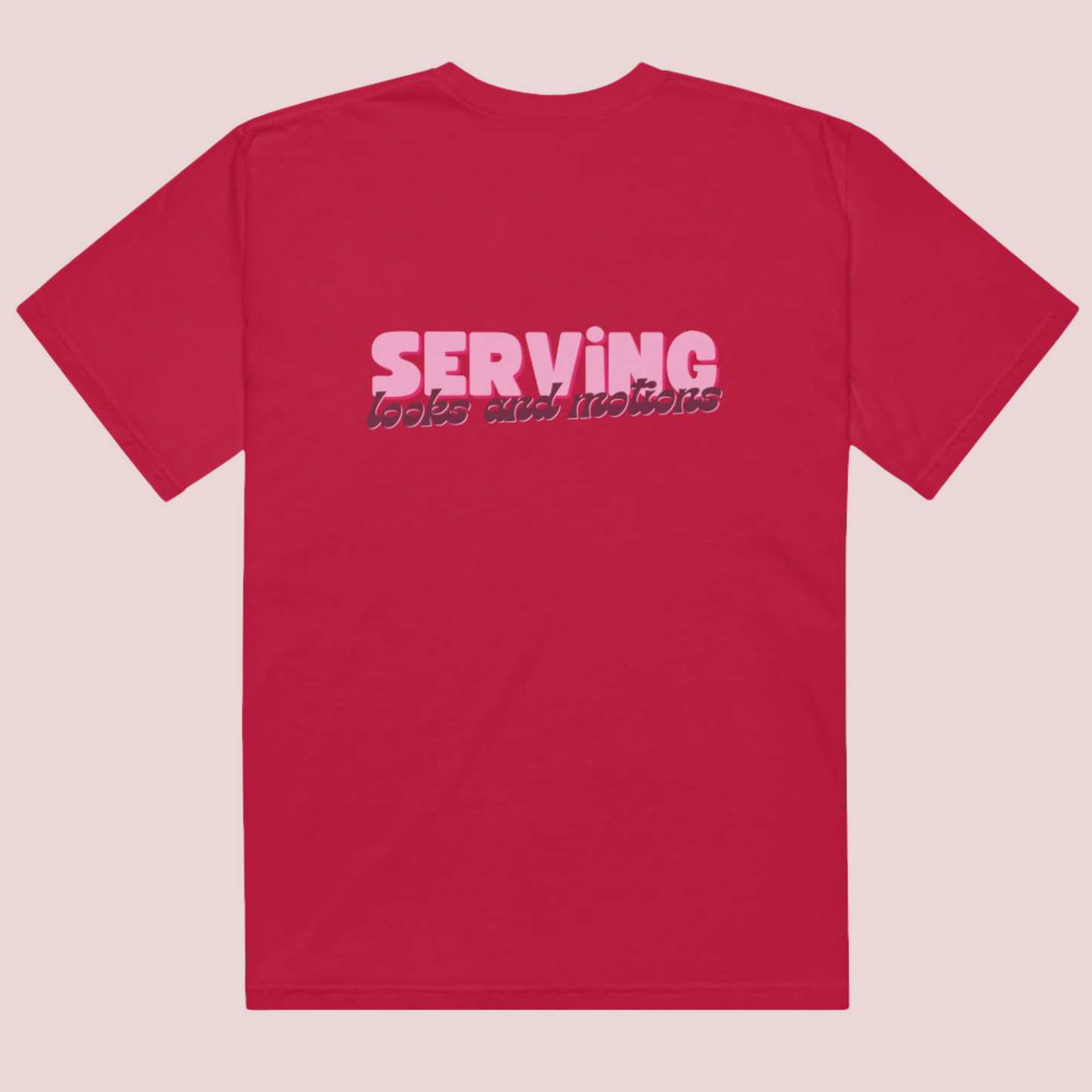 A red roundneck tee showing the text "SERVING looks and motions" in pink font.