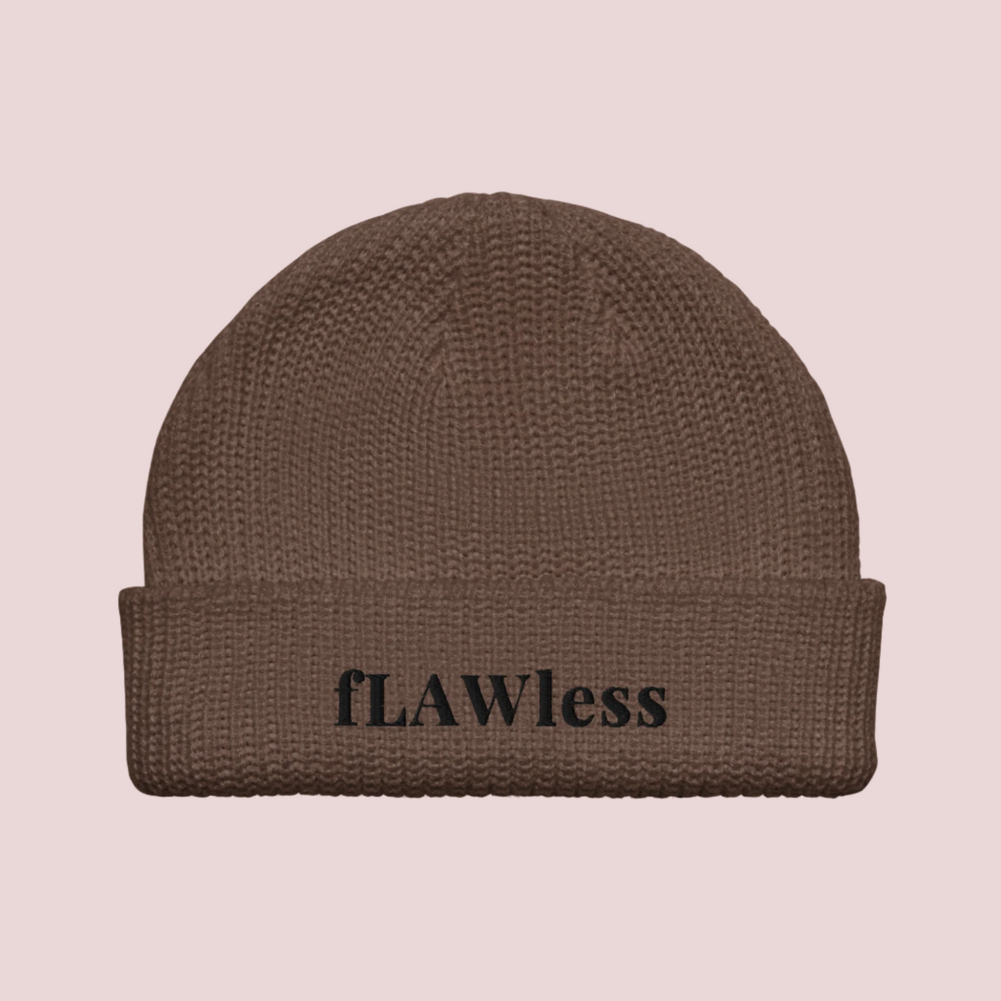 A brown beanie with the text "fLAWless" in black text written on it.
