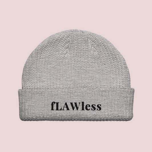 A grey beanie with the text "fLAWless" in black text written on it.