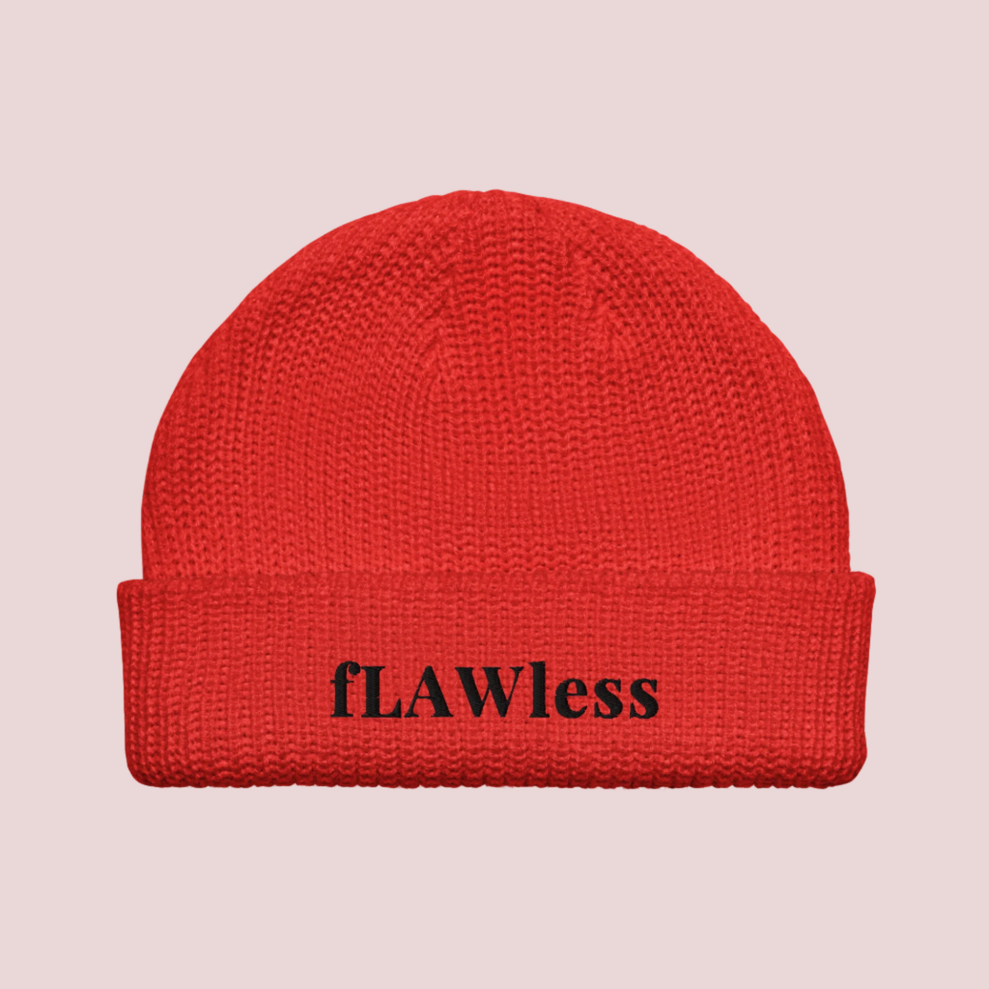 A red beanie with the text "fLAWless" in black text written on it.