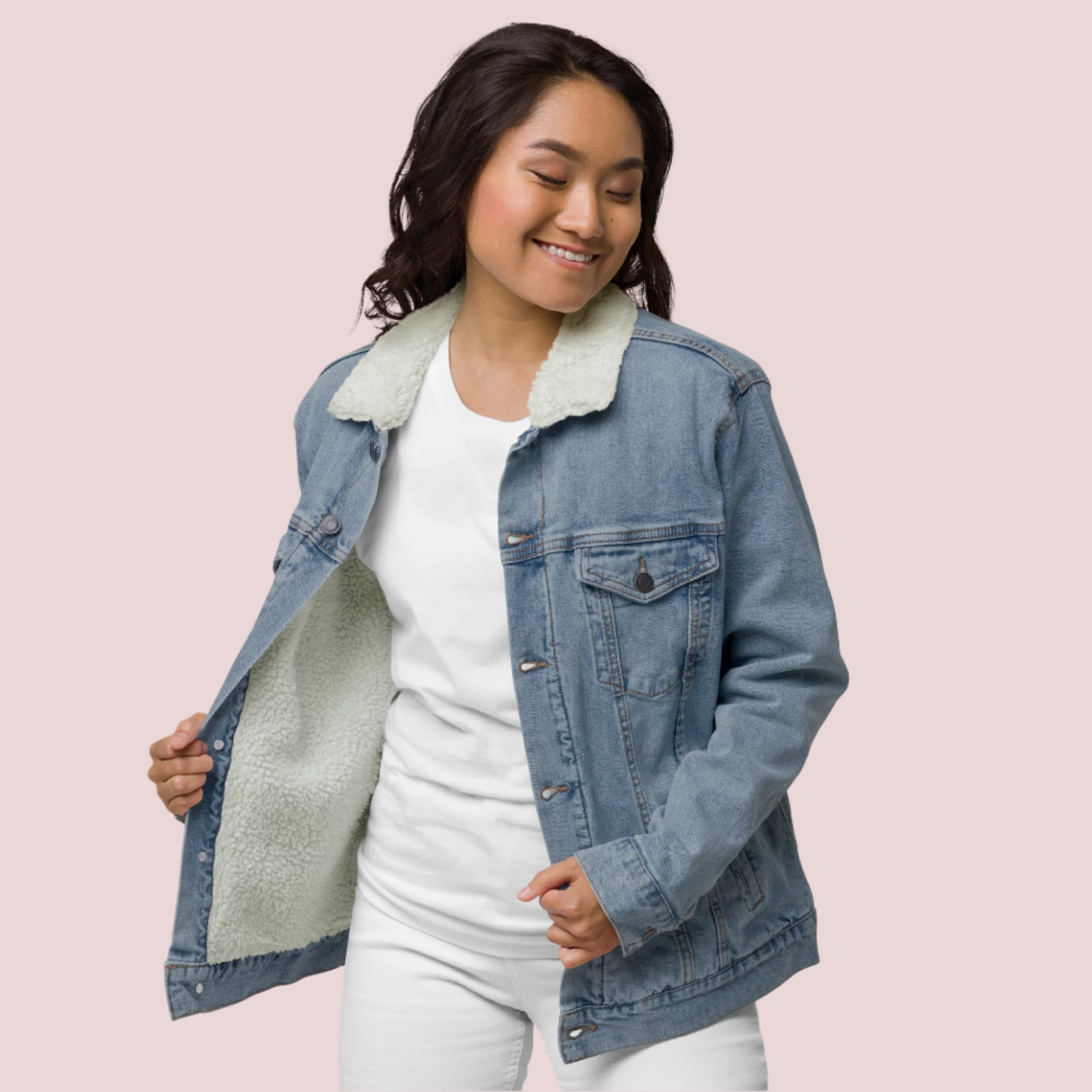 A model wearing a white shirt, pants, and a denim jacket with a soft sherpa lining.