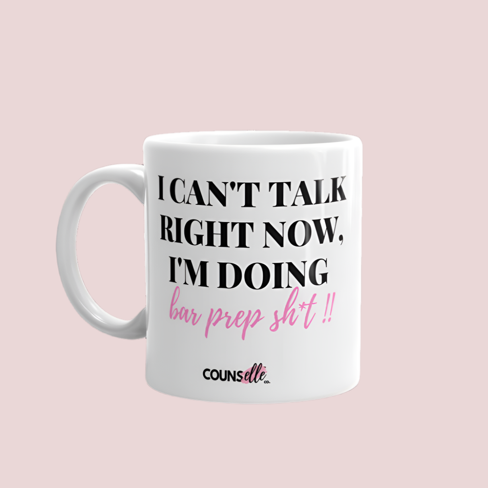 A white mug showing the text "I CAN'T TALK RIGHT NOW, I'M DOING BAR PREP SH*T!", with the counsellecollection logo at the bottom of the text.