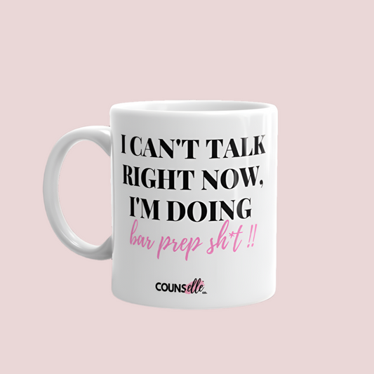 A white mug showing the text "I CAN'T TALK RIGHT NOW, I'M DOING BAR PREP SH*T!", with the counsellecollection logo at the bottom of the text.