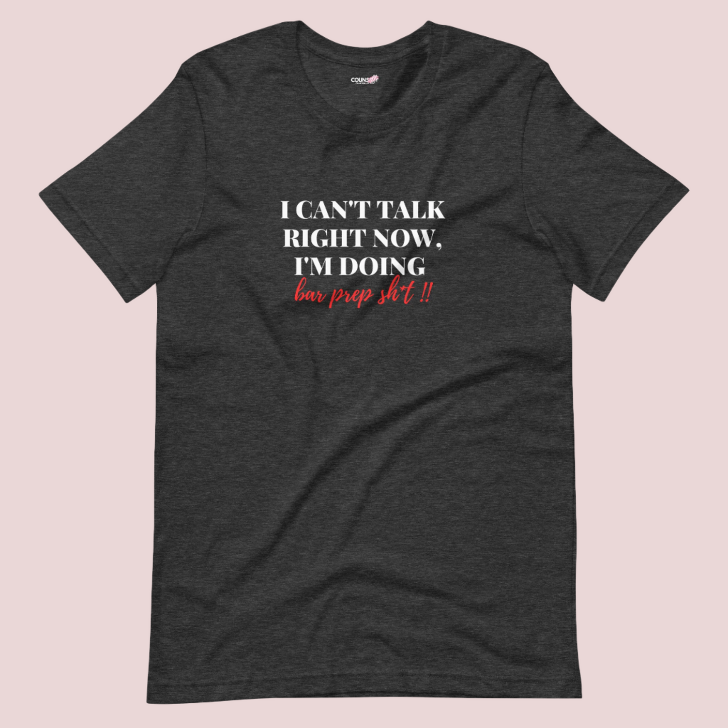 A dark grey roundneck tee showing the text "I CAN'T TALK RIGHT NOW, I'M DOING BAR PREP SH*T!"