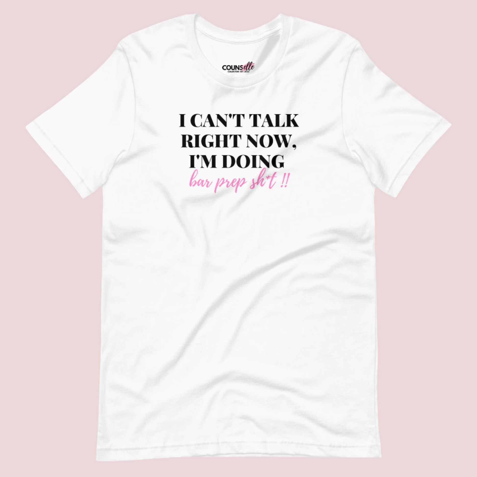 A white roundneck tee showing the text "I CAN'T TALK RIGHT NOW, I'M DOING BAR PREP SH*T!"