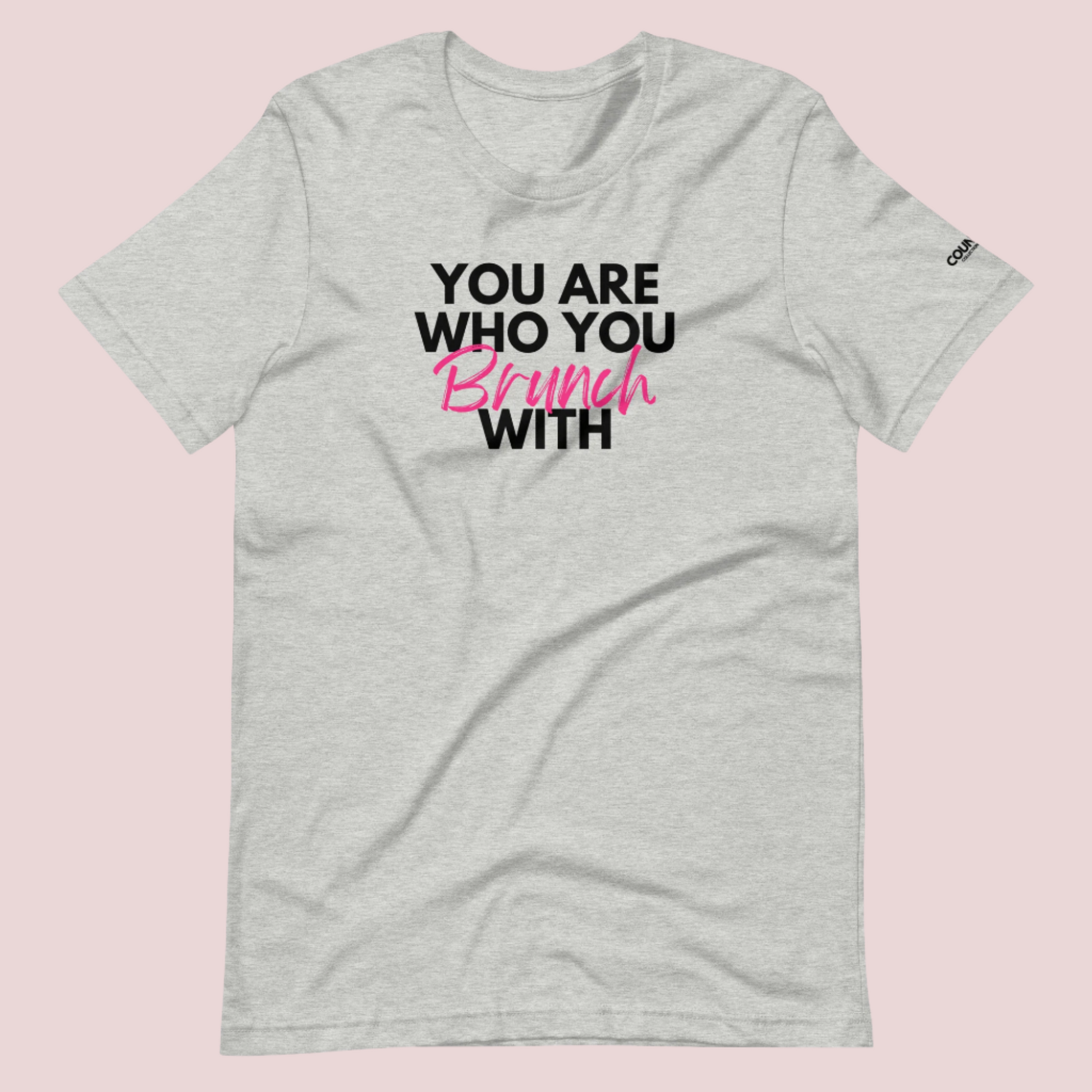 A grey round neck short sleeved shirt featuring the slogan "You are who you brunch with" in front and the counsellecollection logo on the left sleeve.