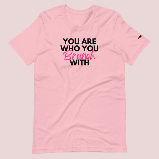 A pink round neck short sleeved shirt featuring the slogan "You are who you brunch with" in front and the counsellecollection logo on the left sleeve.