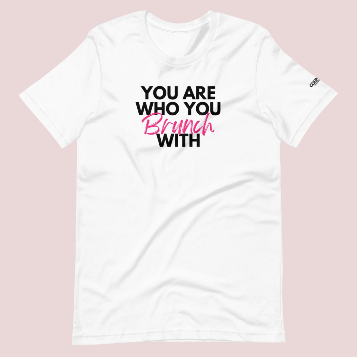 A white round neck short sleeved shirt featuring the slogan "You are who you brunch with" in front and the counsellecollection logo on the left sleeve.
