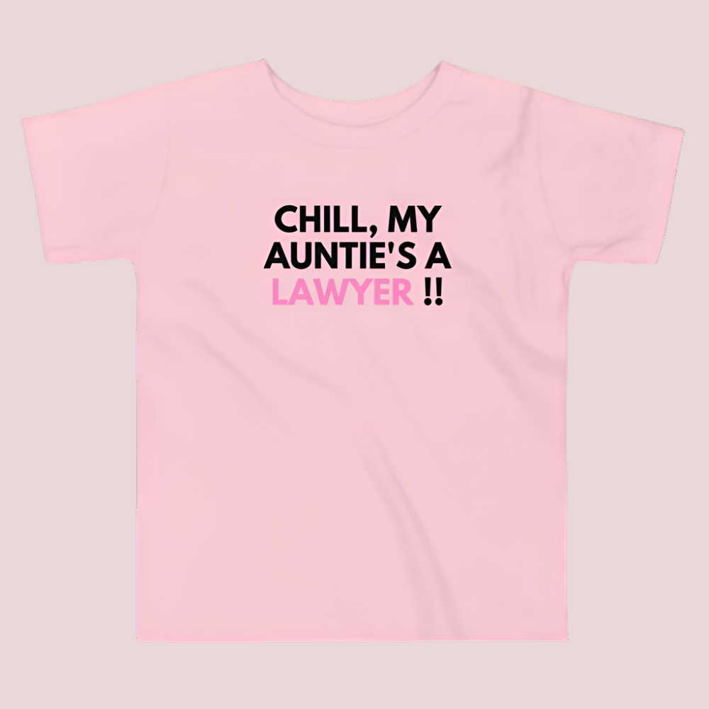 A pink roundneck kid's tee featuring the quote "Chill, my auntie's a lawyer" in uppercase text.