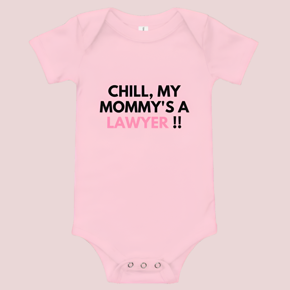 A pink baby onesie with a three-snap leg closure featuring the quote "Chill my mommy's a lawyer" in uppercase block text.