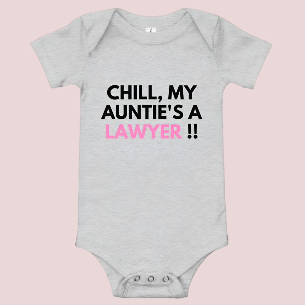 A grey baby onesie with a three-snap leg closure featuring the quote "Chill my auntie's a lawyer" in uppercase block text.