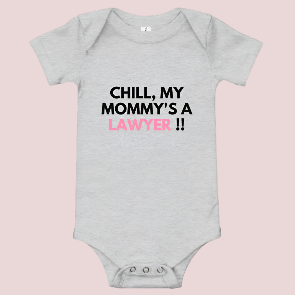 A grey baby onesie with a three-snap leg closure featuring the quote "Chill my mommy's a lawyer" in uppercase block text.