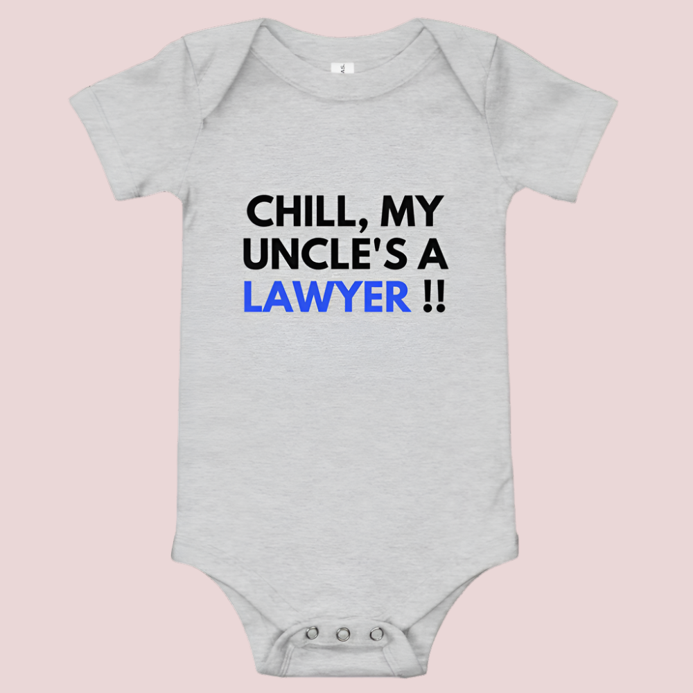 A grey baby onesie with a three-snap leg closure featuring the quote "Chill my uncle's a lawyer" in uppercase block text.