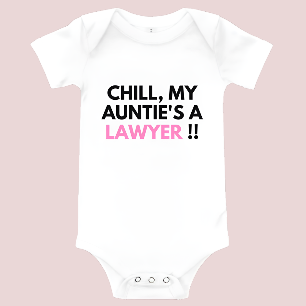 A white baby onesie with a three-snap leg closure featuring the quote "Chill my auntie's a lawyer" in uppercase block text.