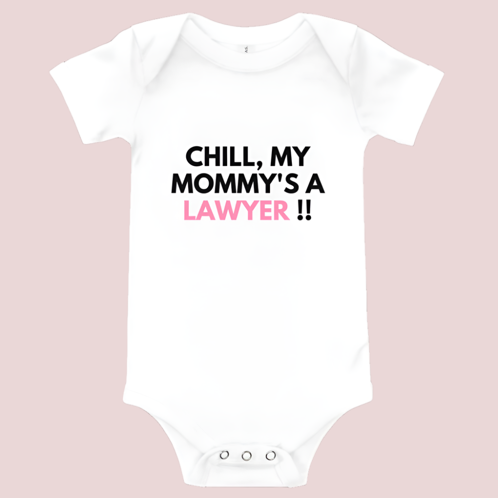 A white baby onesie with a three-snap leg closure featuring the quote "Chill my mommy's a lawyer" in uppercase block text.