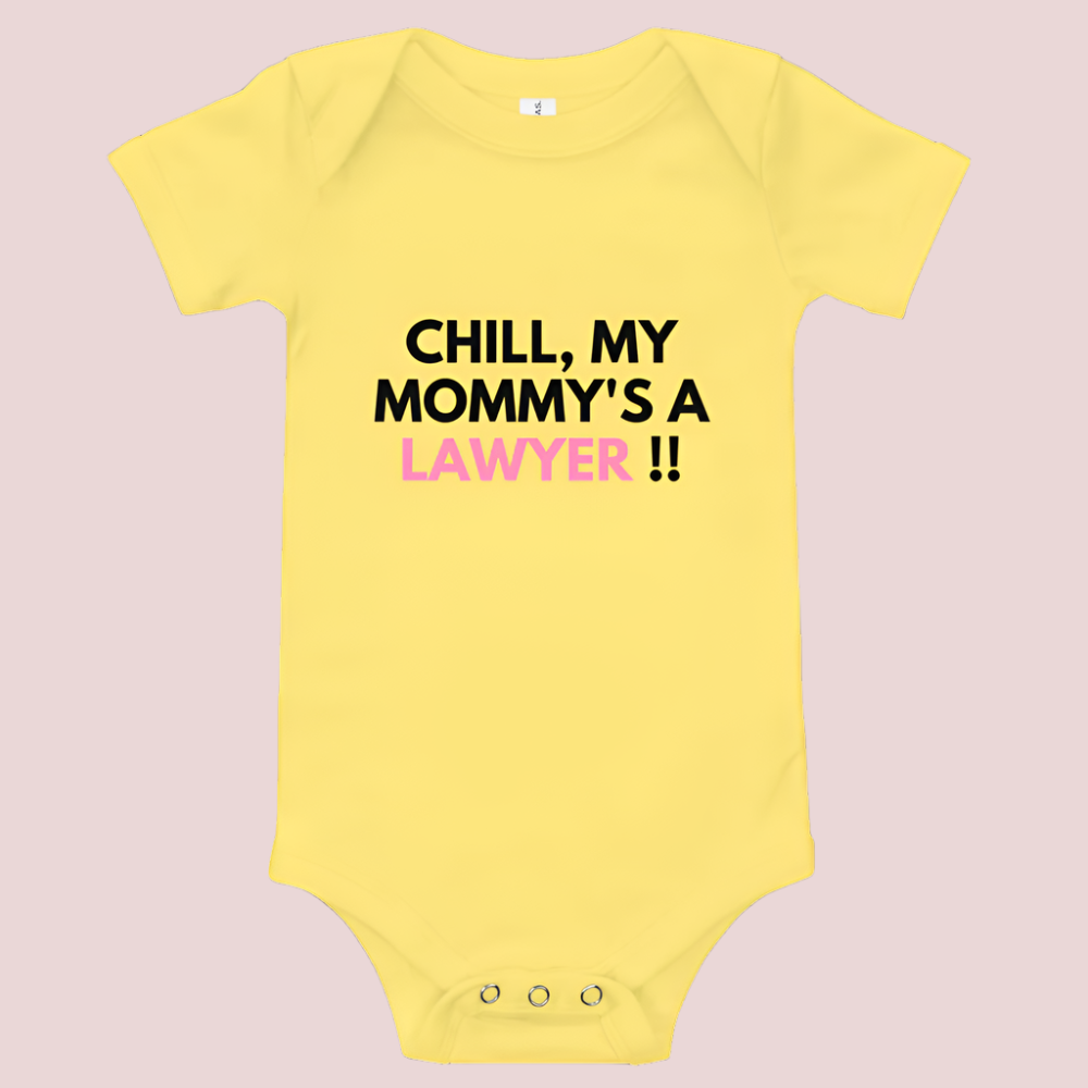 A yellow baby onesie with a three-snap leg closure featuring the quote "Chill my mommy's a lawyer" in uppercase block text.