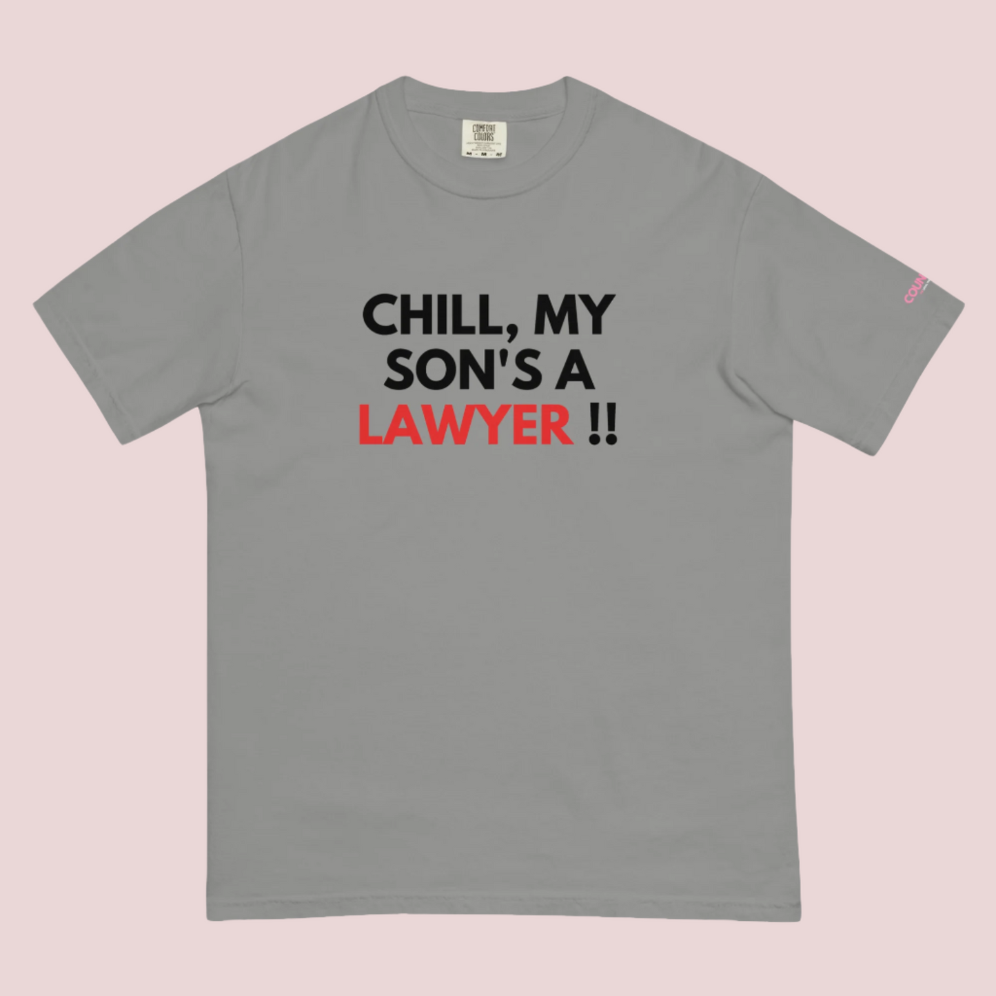 A grey roundneck t-shirt with the slogan "CHILL MY SON'S A LAWYER." and the counsellecollection logo on the left sleeve.