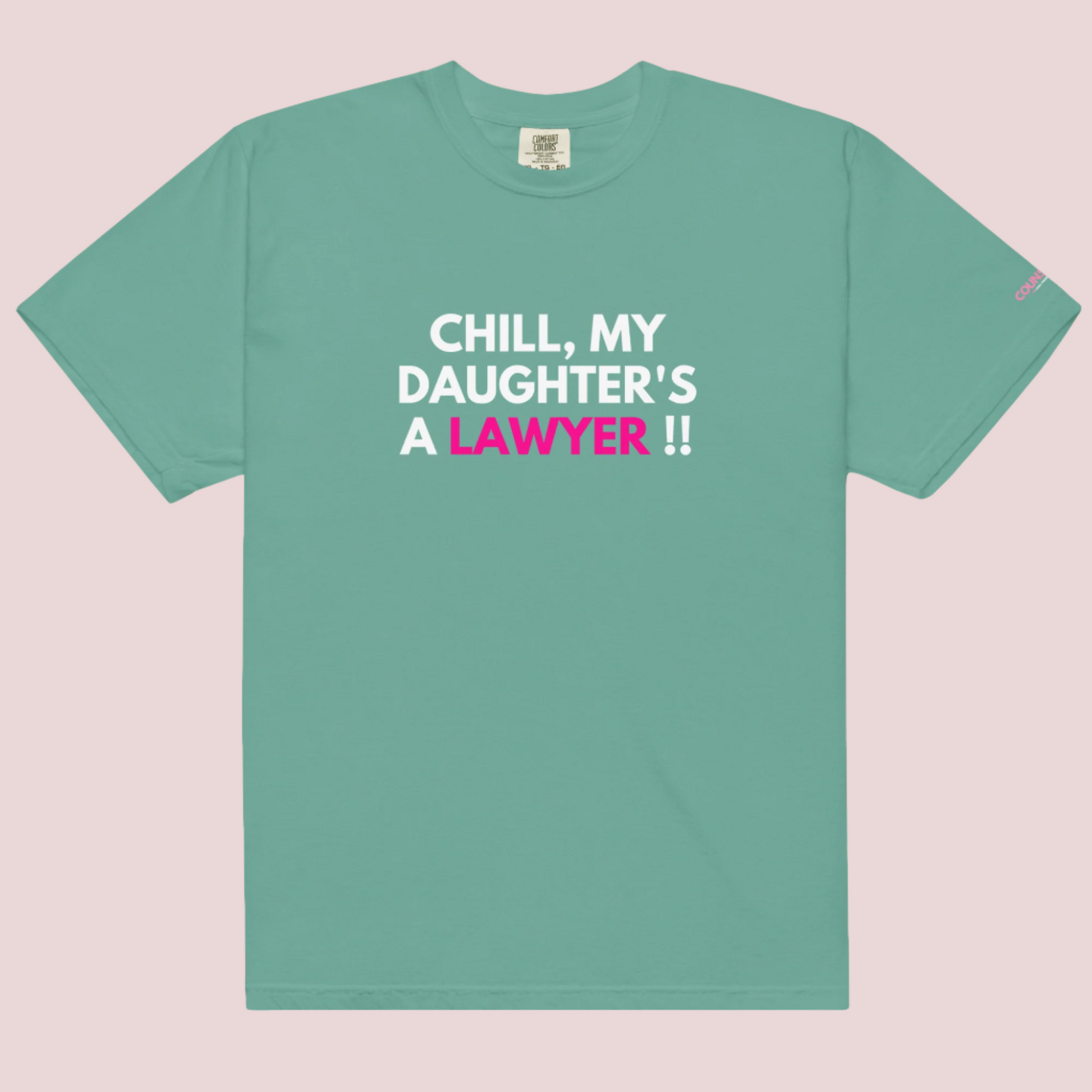 A seafoam roundneck t-shirt with the slogan "CHILL MY DAUGHTER'S A LAWYER." and the counsellecollection logo on the left sleeve.