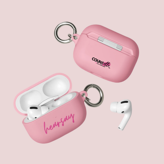 Two pink AirPods Cases showing the word "hearsay" in script font on one of the cases and the counsellecollection logo on the other. A single airpod can also be seen beside one of the cases.