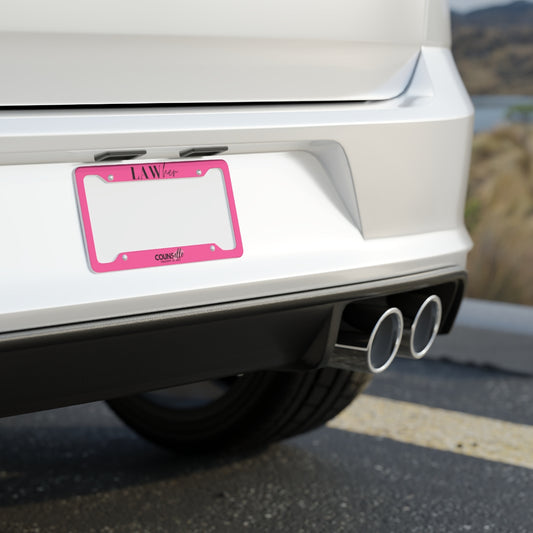 A white car showing a pink license plate frame with the text "LAWher" at the top part and the counsellecollection logo at the bottom of the design.