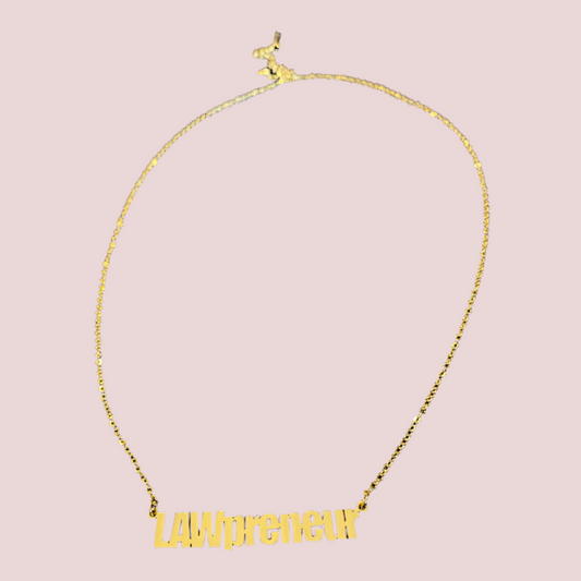 A gold chain necklace featuring the coined term "LAWpreneur" in block sans serif font.