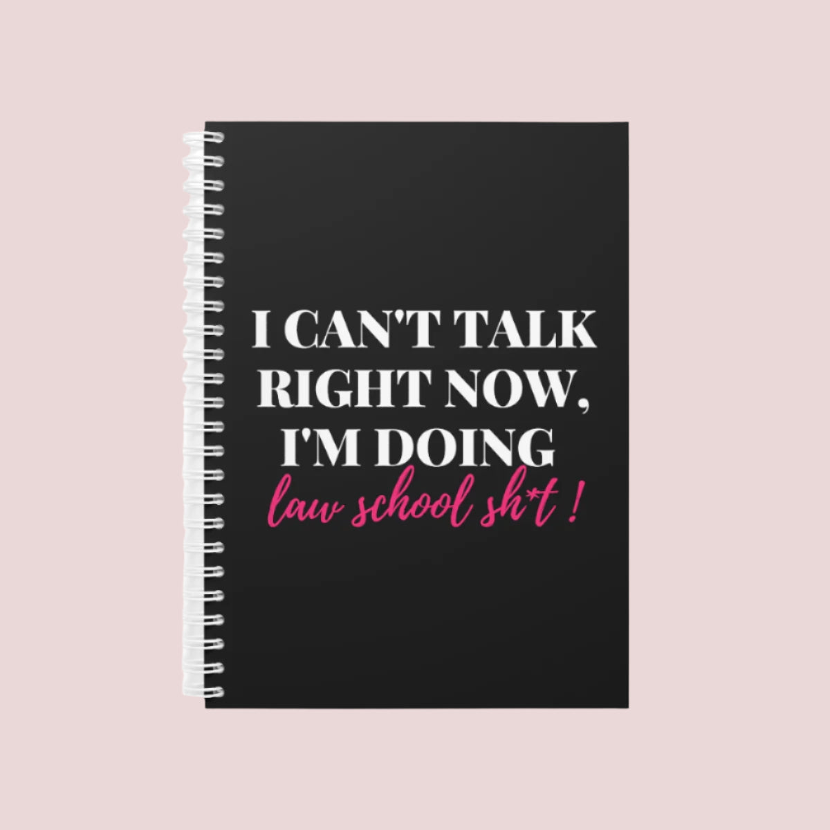 A black wire bound notebook with the text "I can't talk right now, I'm doing law school sh*t" on the cover.