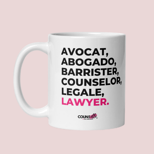 A white mug with the text "avocat", "abogado", "barrister", "counselor", "legale", and "lawyer" on the front. Counselle Collection® logo under text.