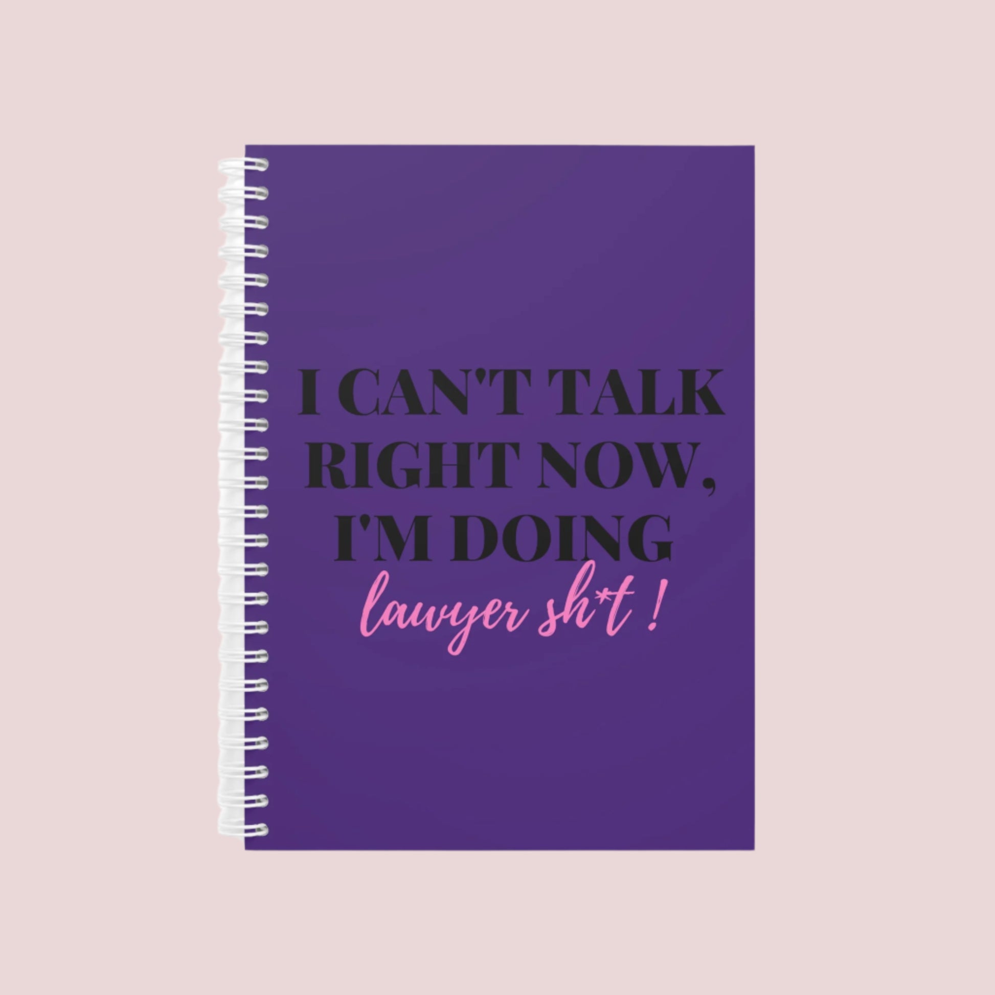 A purple notebook with the phrase "I can’t talk right now, I’m doing Lawyer sh*t" on the front cover. Ring-bound with ruled pages.