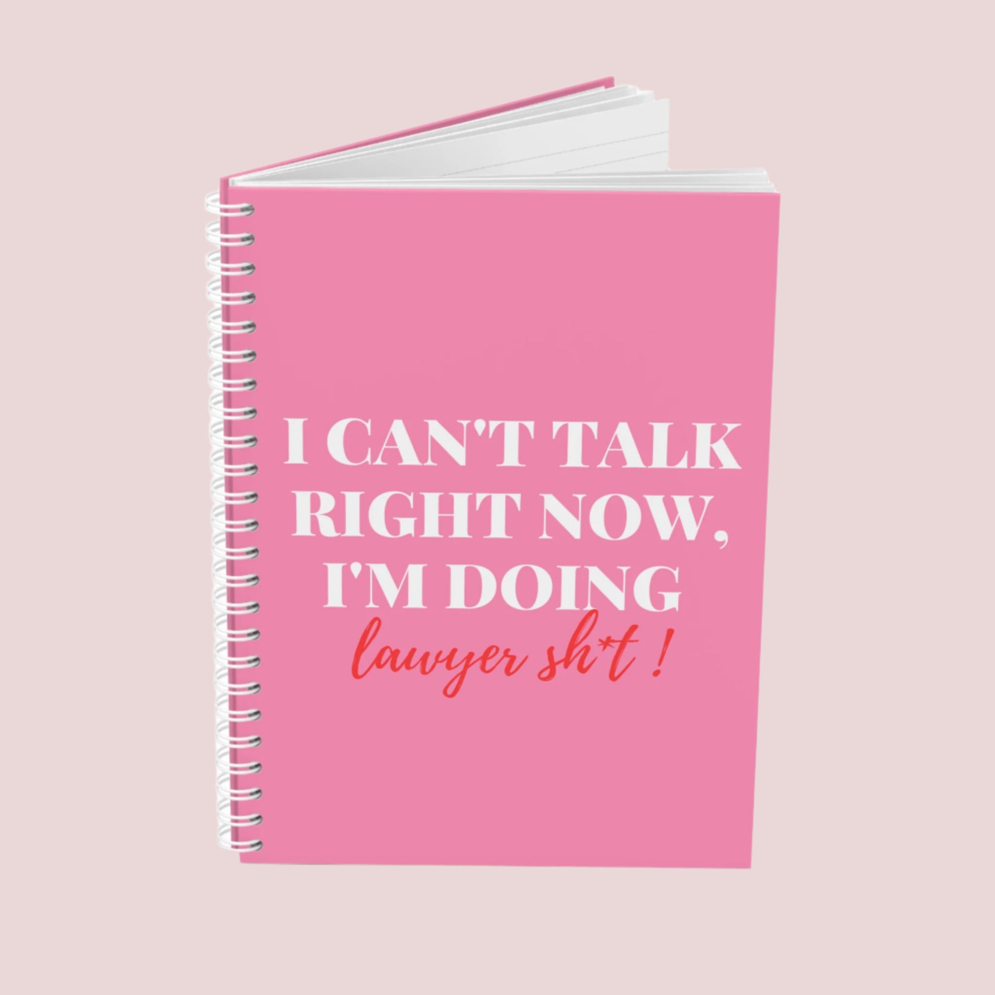 A pink notebook with the phrase "I can’t talk right now, I’m doing Lawyer sh*t" on the cover. Ring-bound with ruled pages.