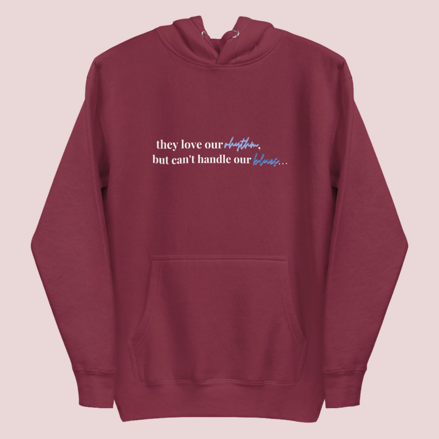 A maroon crewneck long-sleeved hoodie with the text "they love our rhythm but can't handle our blues"